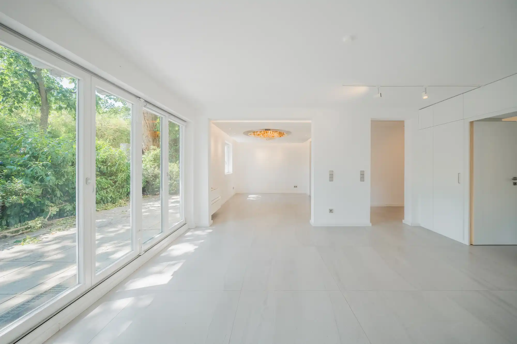 Heller Wohnraum mit raumhoher Glasfront zur Terrasse